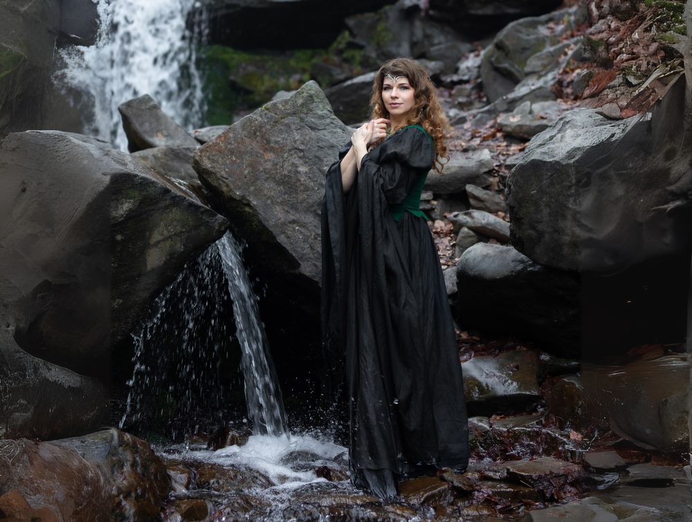 dark green fantasy dress Woman in Green Fantasy Dress Stock Photo